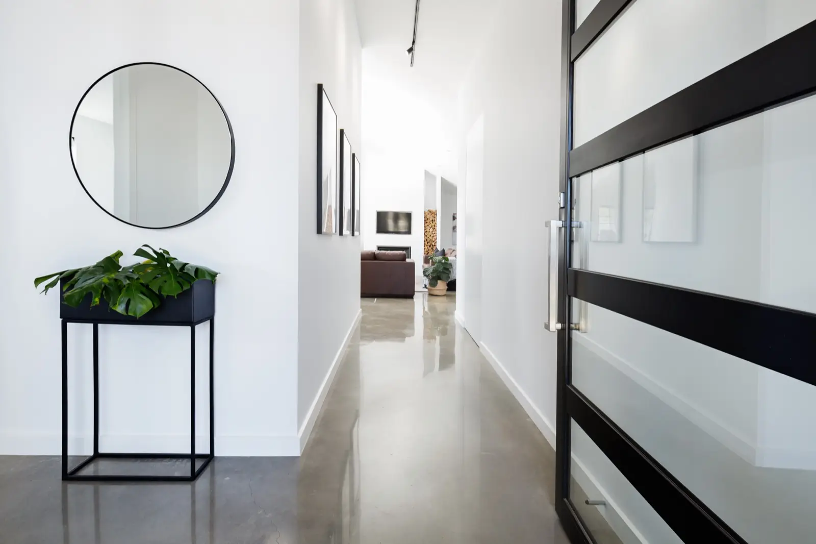 Contemporary home entry hallway with polished concrete floors